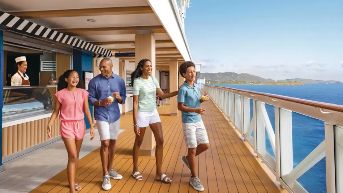 A family walking along a ship’s promenade deck