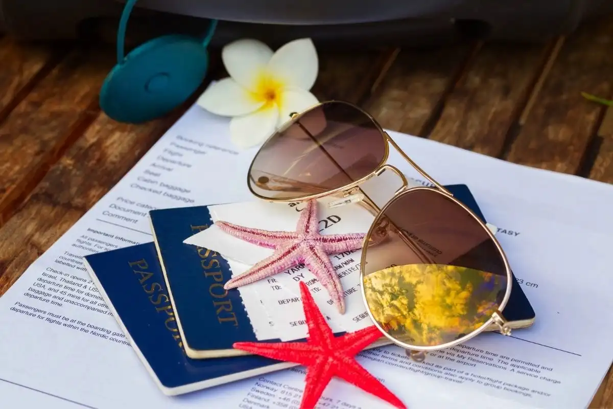 A flat-lay of passports, sunglasses, a starfish and a map