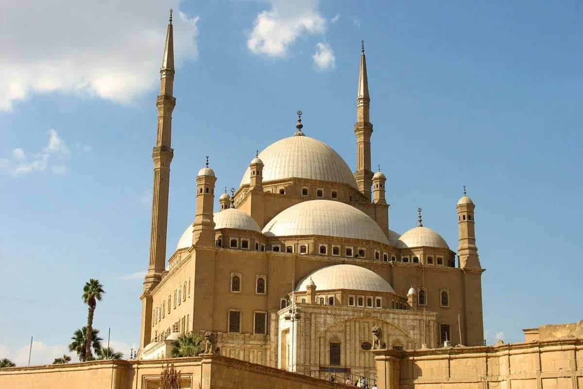 The Alabaster Mosque of Muhammad Ali on Cairo's Citadel, its stacked domes and two pencil minarets against a blue sky