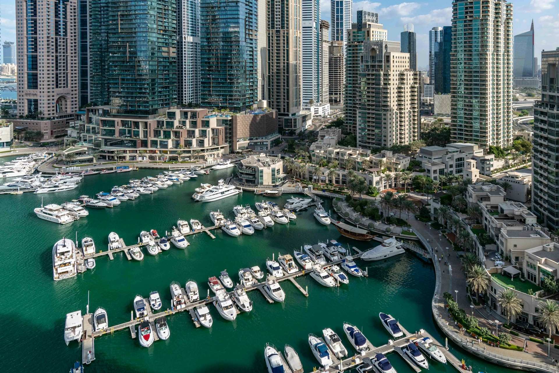 Yachts moored in Dubai Marina, with the residential towers rising behind the water