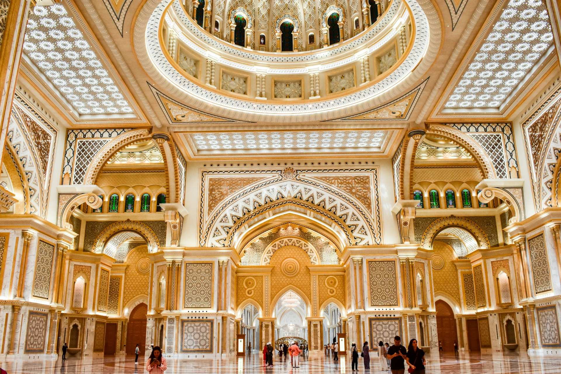 The gold and white domed hall of Qasr Al Watan in Abu Dhabi, a chandelier hanging at its centre