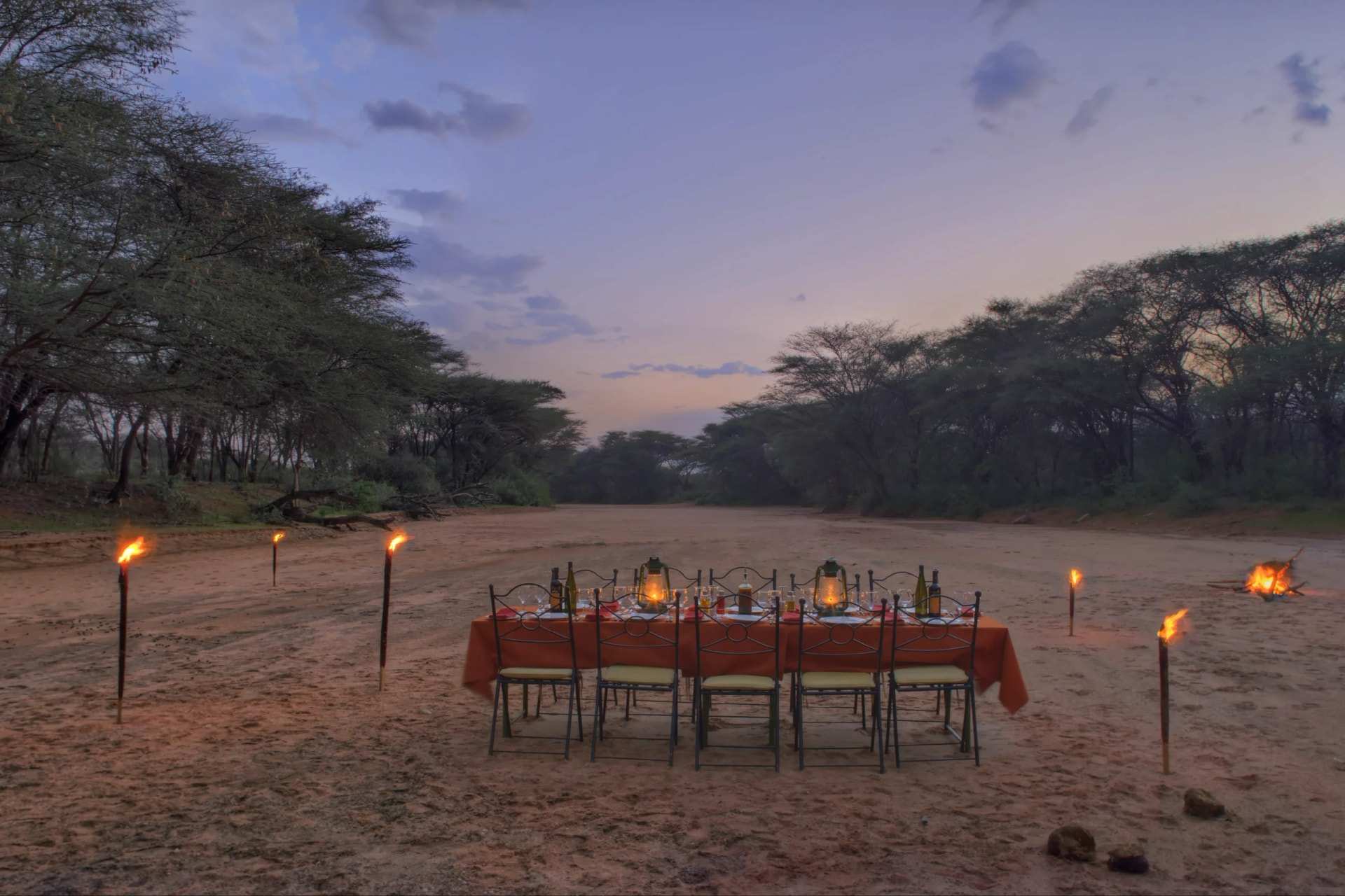 Table laid for a bush dinner in a dry river bed, Samburu