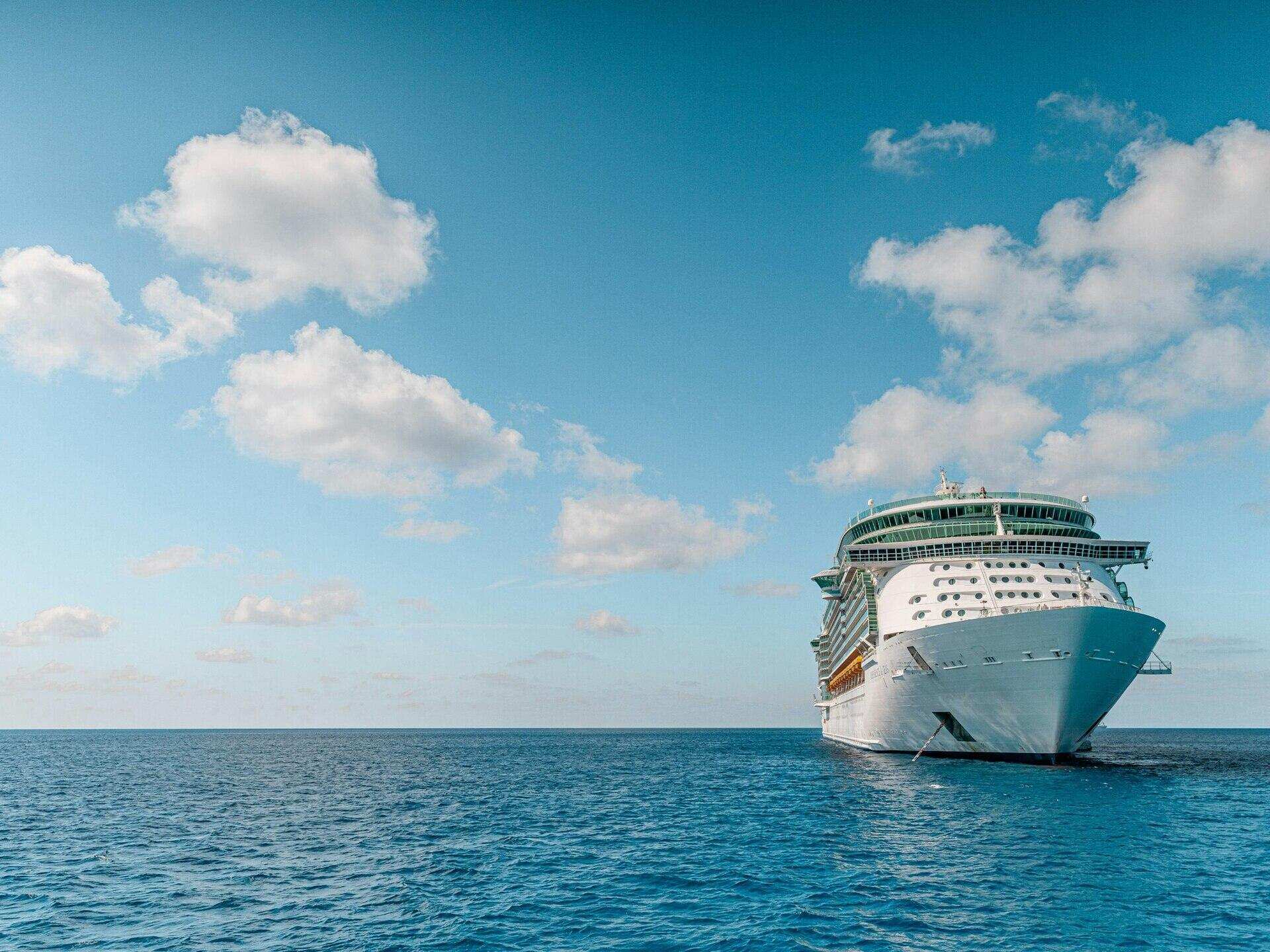 A cruise ship at sea under a clear sky
