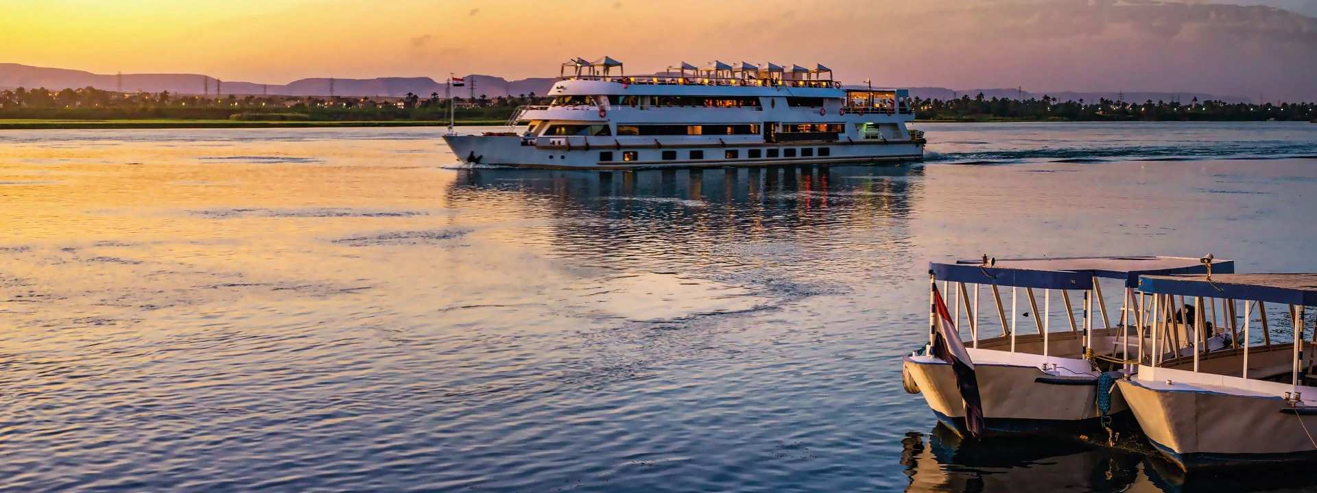 A river cruise boat moored at dusk